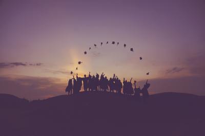 Decorative - silhouette of people standing on a hill.