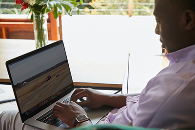 Man sitting in front of a laptop