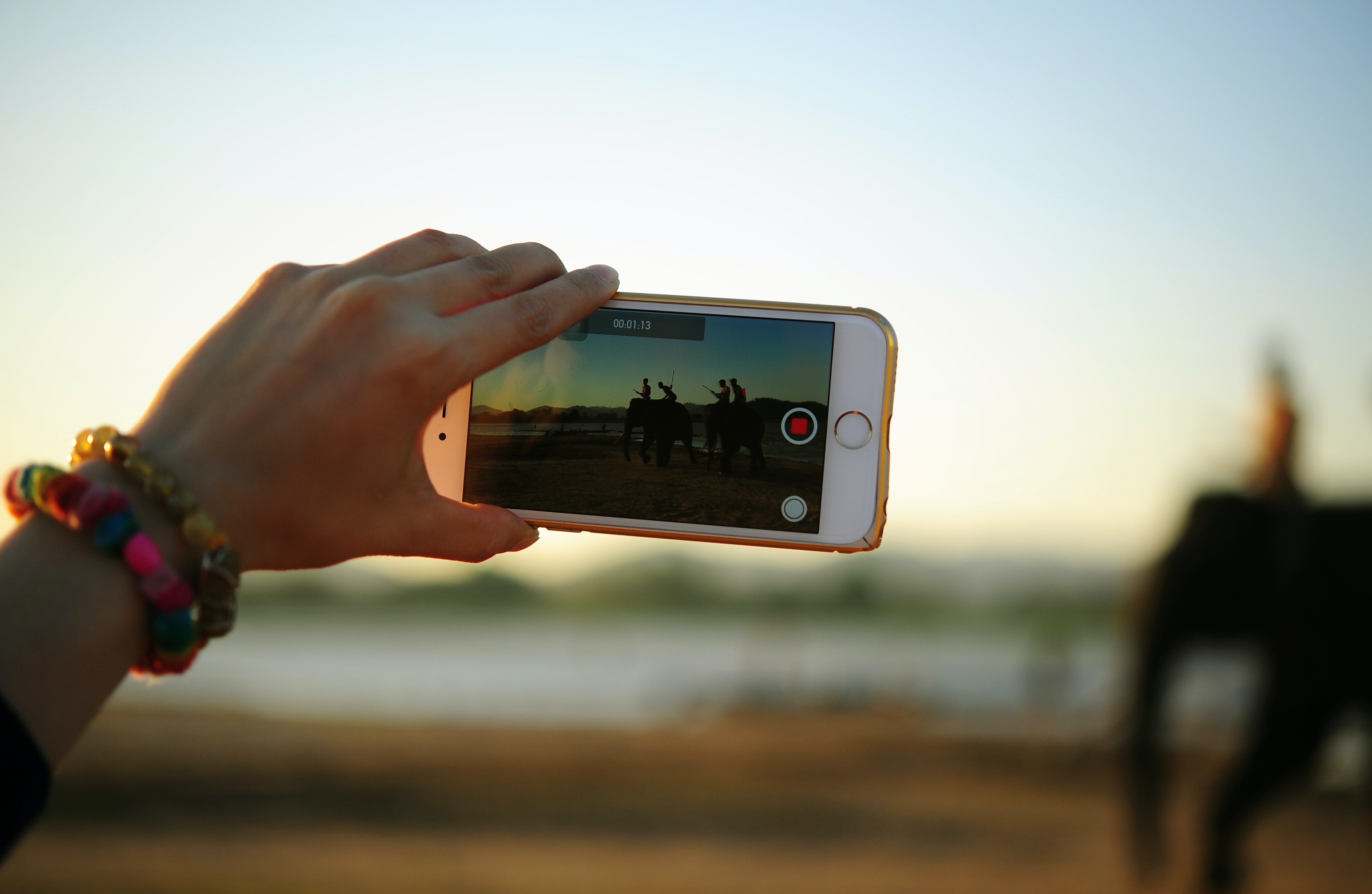 hand holding a phone with the video recorder on